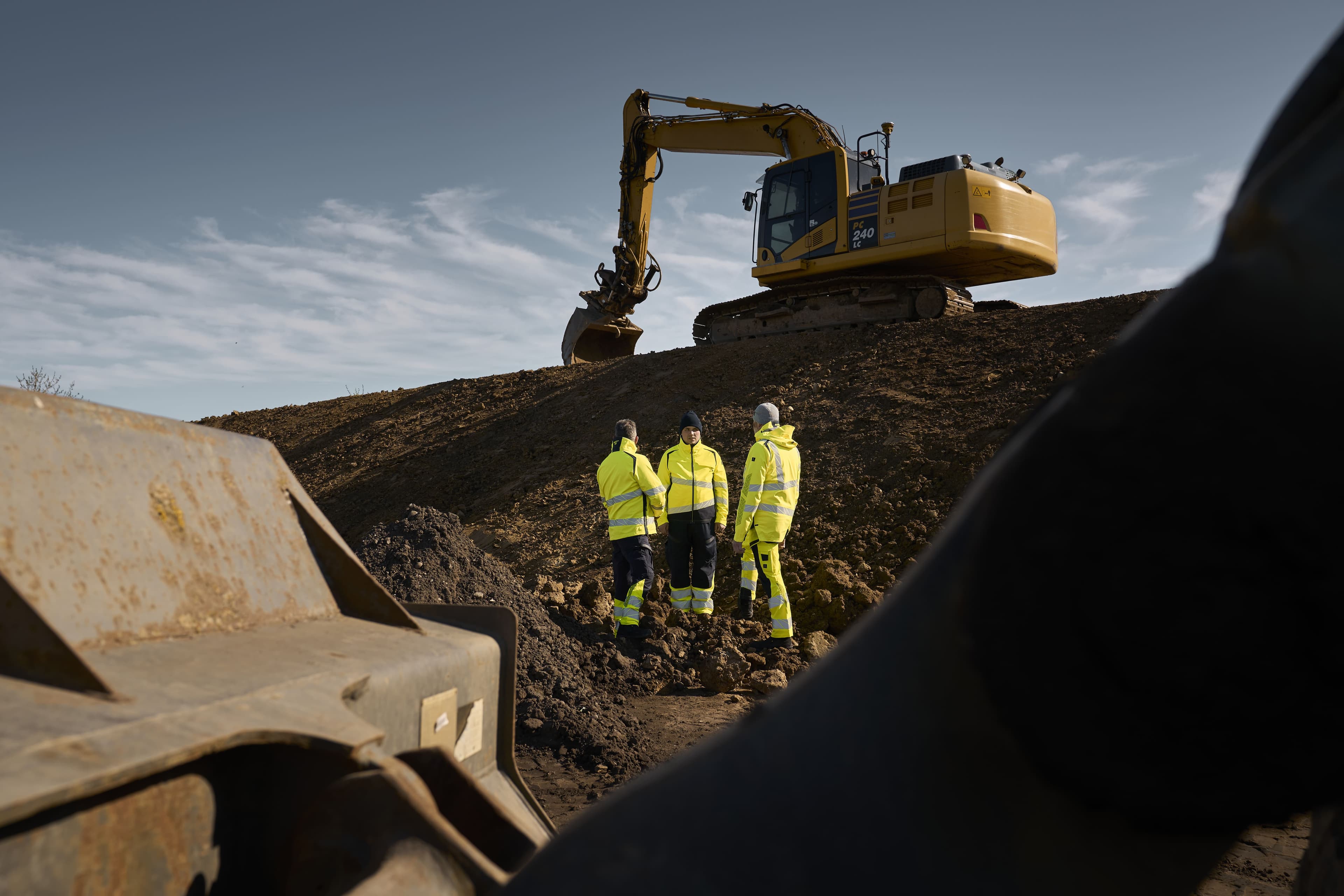 Professionals in safety gear working at an industrial site